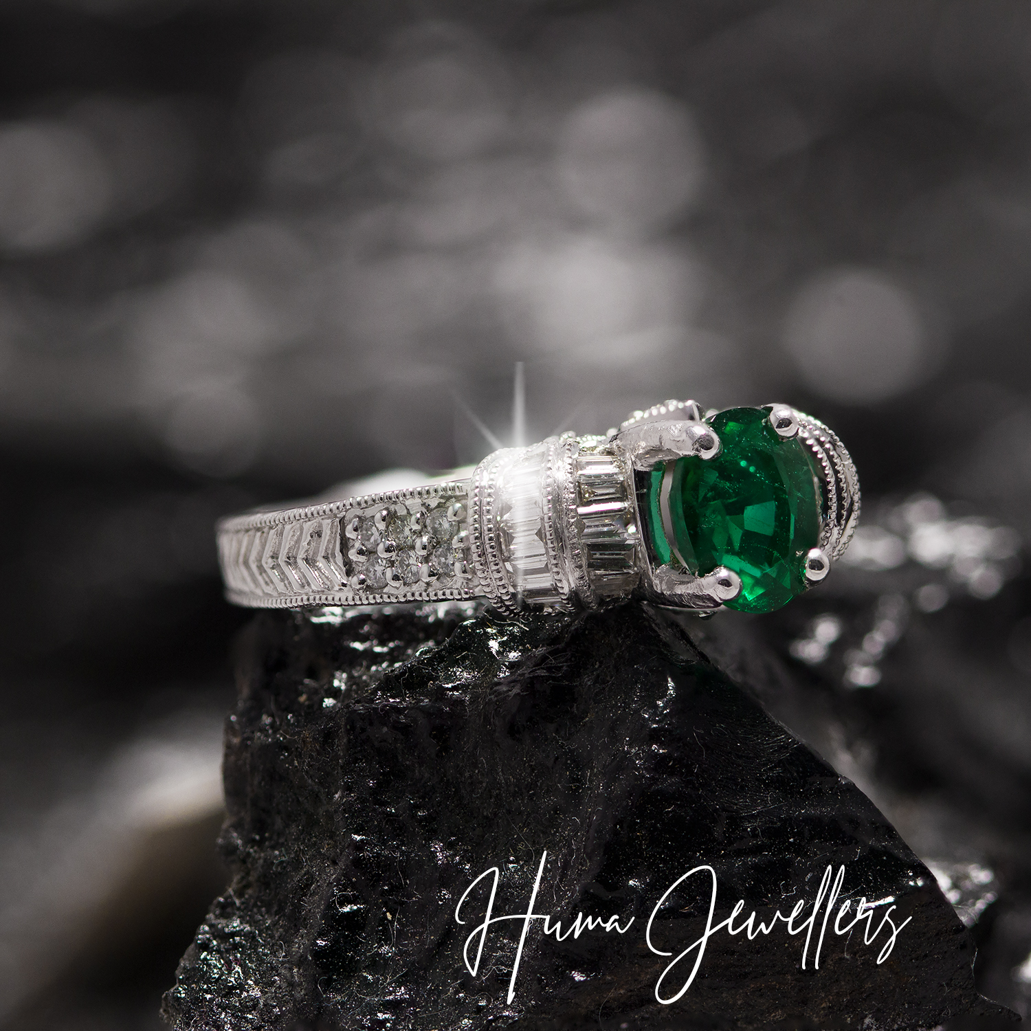 wedding engagement ring in solitaire style with green emerald stone with baguettes and round diamonds at huma jewellers karachi pakistan